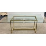 A contemporary heavy plate glass top and gilt metal base dining table, 180 x 90cm.