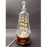 A glass ship in a bottle table lamp, H. 41cm.