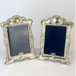 A pair of hallmarked silver wooden backed photo frames, H. 21cm.