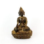 A Tibetan gilt bronze figure of a seated Buddha, H. 14cm.