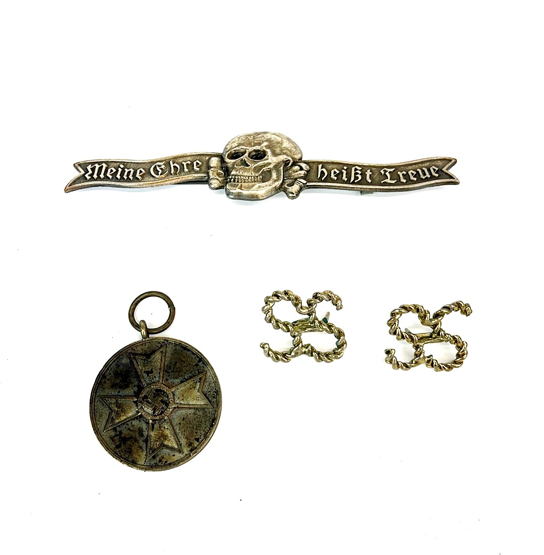 A German bar brooch with two SS pins and a 1939 Nazi pendant.