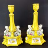 A pair of Sevres style continental porcelain candlesticks, H. 32cm.