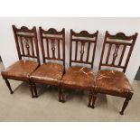 A set of four 20th C leather upholstered dining chairs, damage to upholstery, evident in photos.