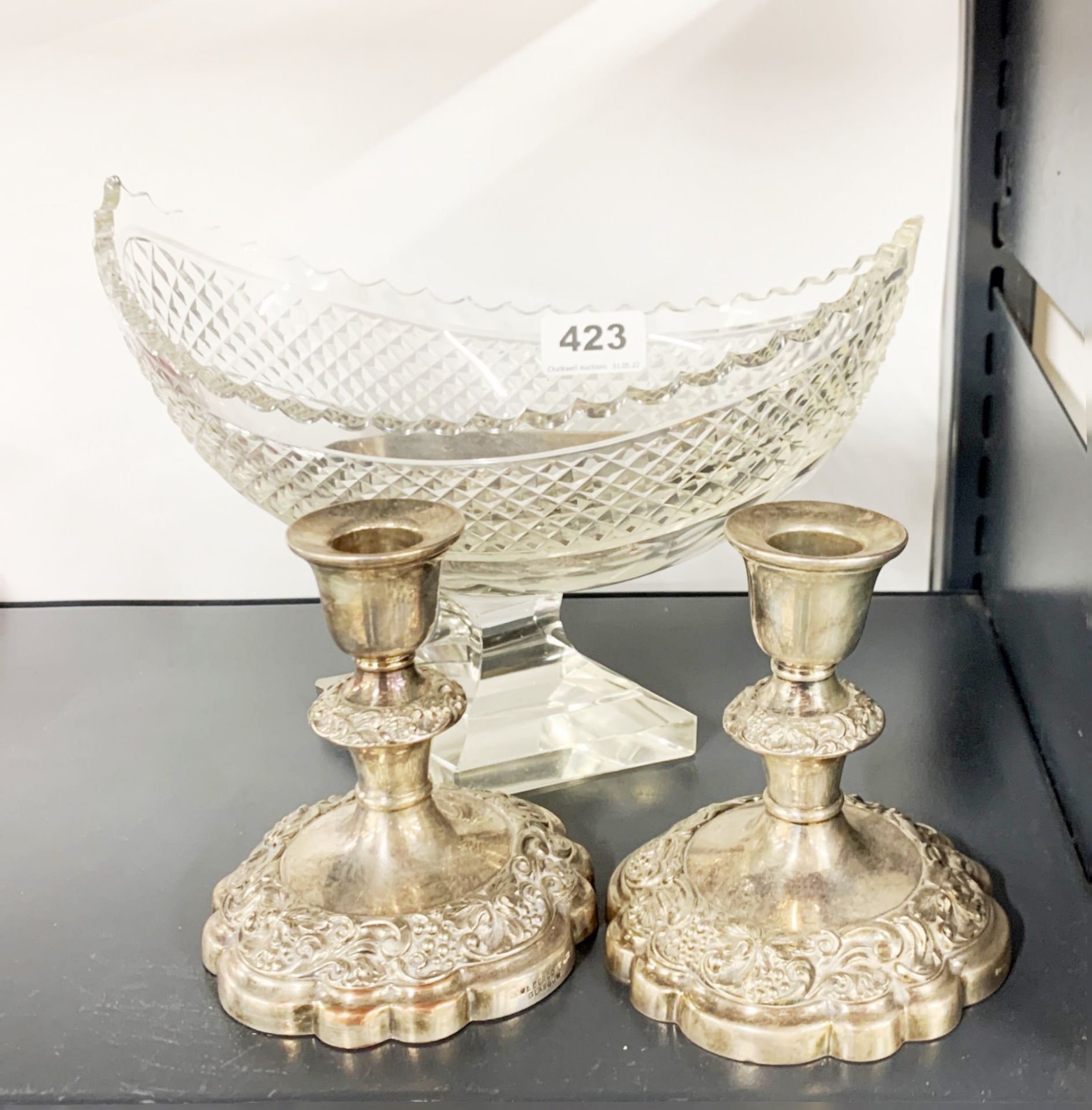 A fine cut crystal boat shaped bowl, W. 25cm, together with a pair of silver plated candlesticks,