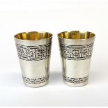 A pair of hallmarked .875 silver niello decorated and gilt lined spirit cups.