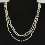 A three-row mixed coloured freshwater pearl necklace, L. 48cm. Pearl Dia. Between 1-2mm.