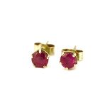 A pair of hallmarked 18ct yellow gold stud earrings set with round cut rubies, L. 0.5cm.