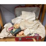 An Armand Marseille composition doll with a vanity case of doll related and fabric items.