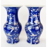 A pair of Chinese hand painted prunus pattern porcelain vases with flared necks, H. 38cm.