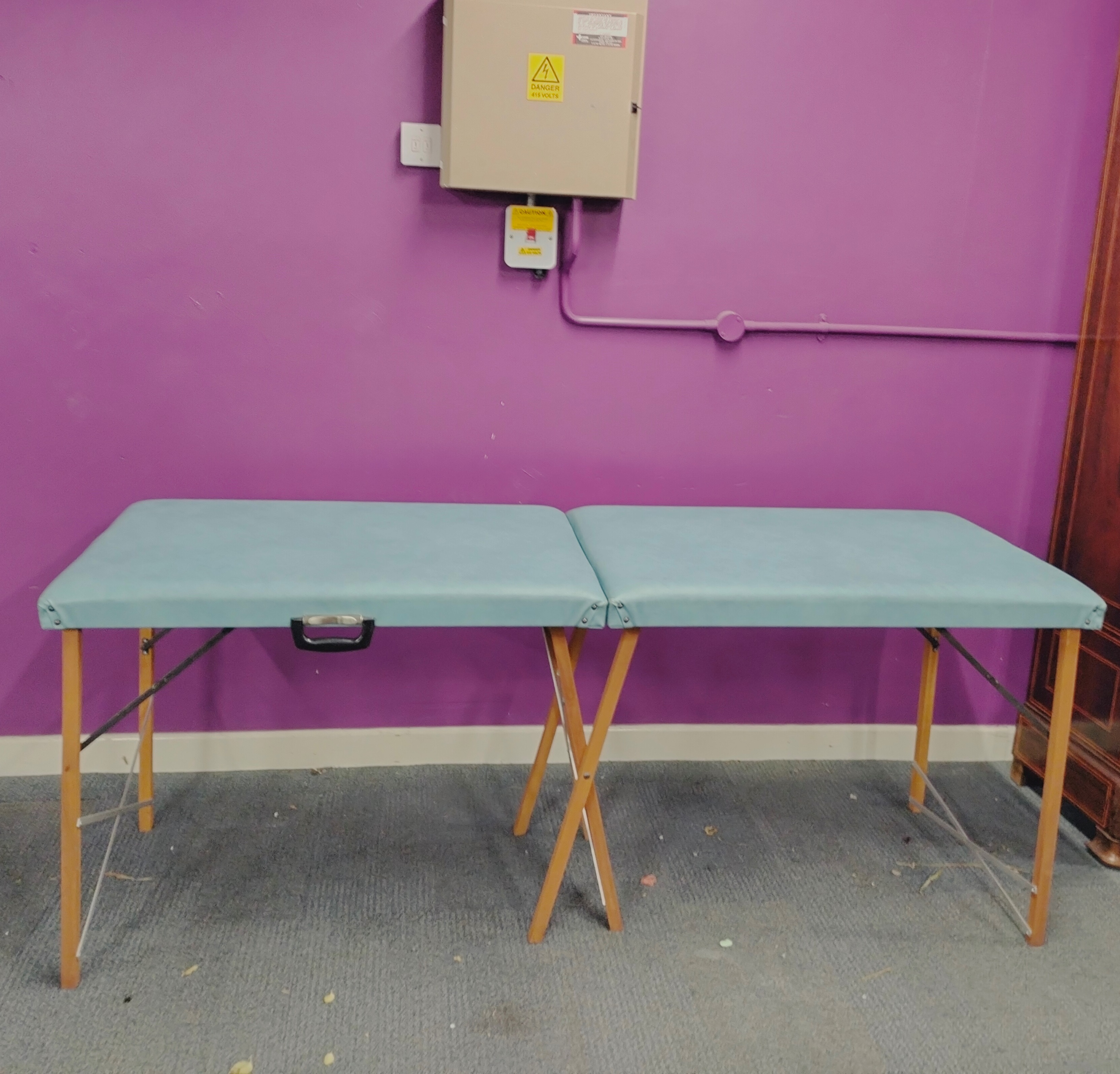 A cased massage table, cased 92 x 62cm.