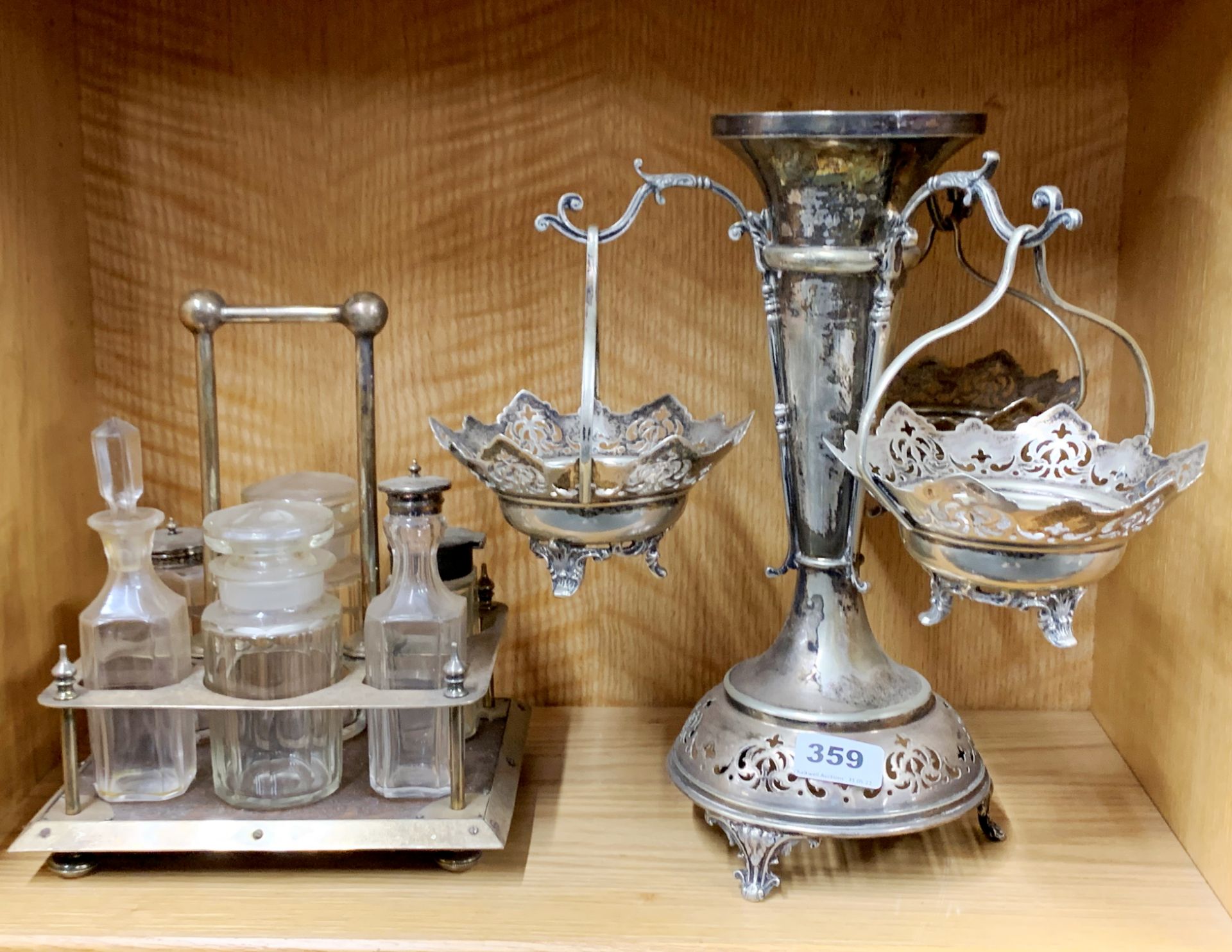 A large silver plated table centrepiece, H. 34cm, together with an oak and silver plate cruet set.