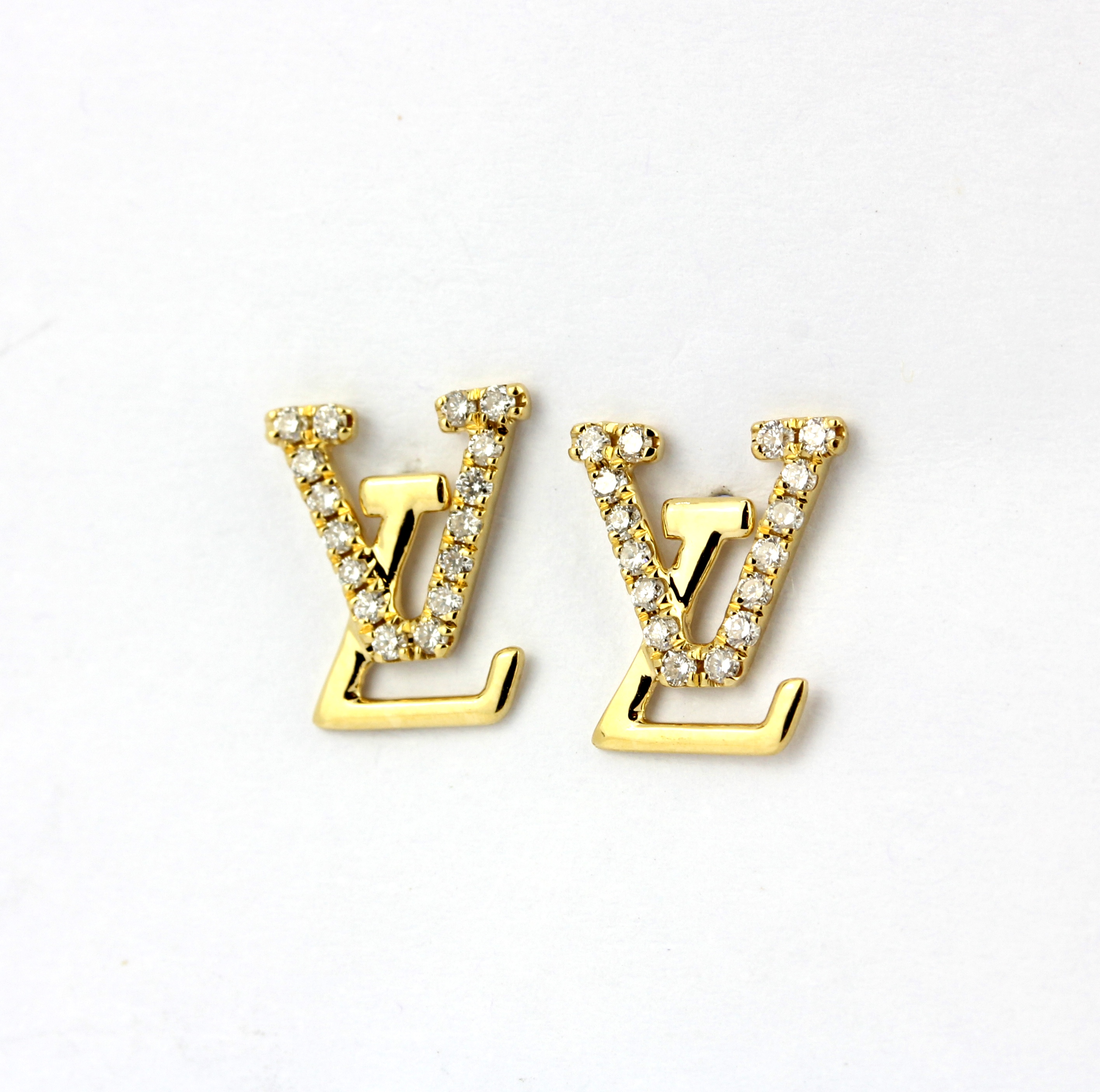 A pair of 18ct yellow gold and diamond set stud earrings, L. 1cm.