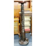 A carved mahogany torchere stand, slightly loose top platform, H. 157cm.