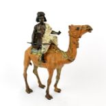 An Austrian cold painted bronze figure of an Arab riding a camel, stamped to base, possibly