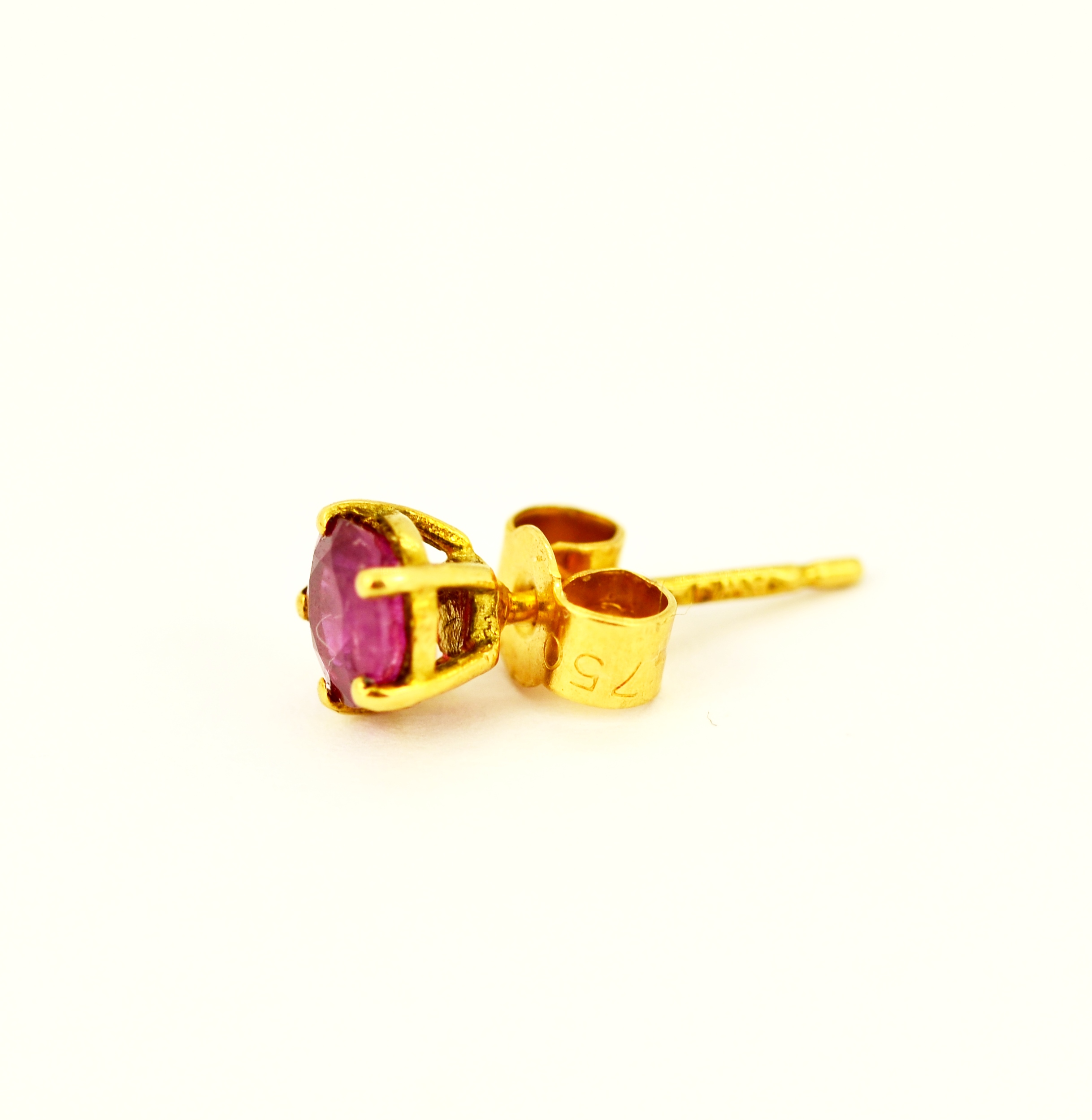 A pair of hallmarked 18ct yellow gold stud earrings set with round cut rubies, L. 0.5cm. - Image 2 of 3