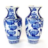 A pair of 19th century oriental hand painted blue and white porcelain vases, H. 30cm.