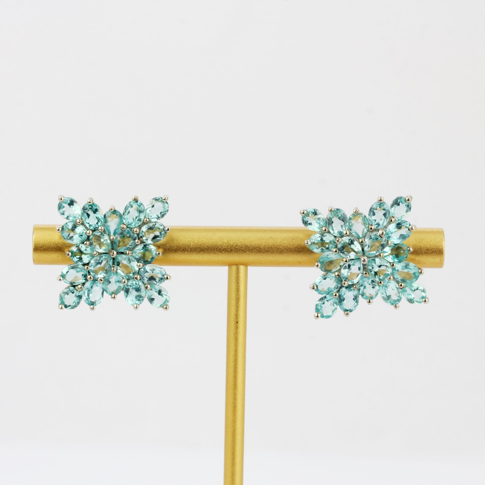 A pair of 9ct white gold cluster earrings set with oval cut apatite's, L. 2.1cm.