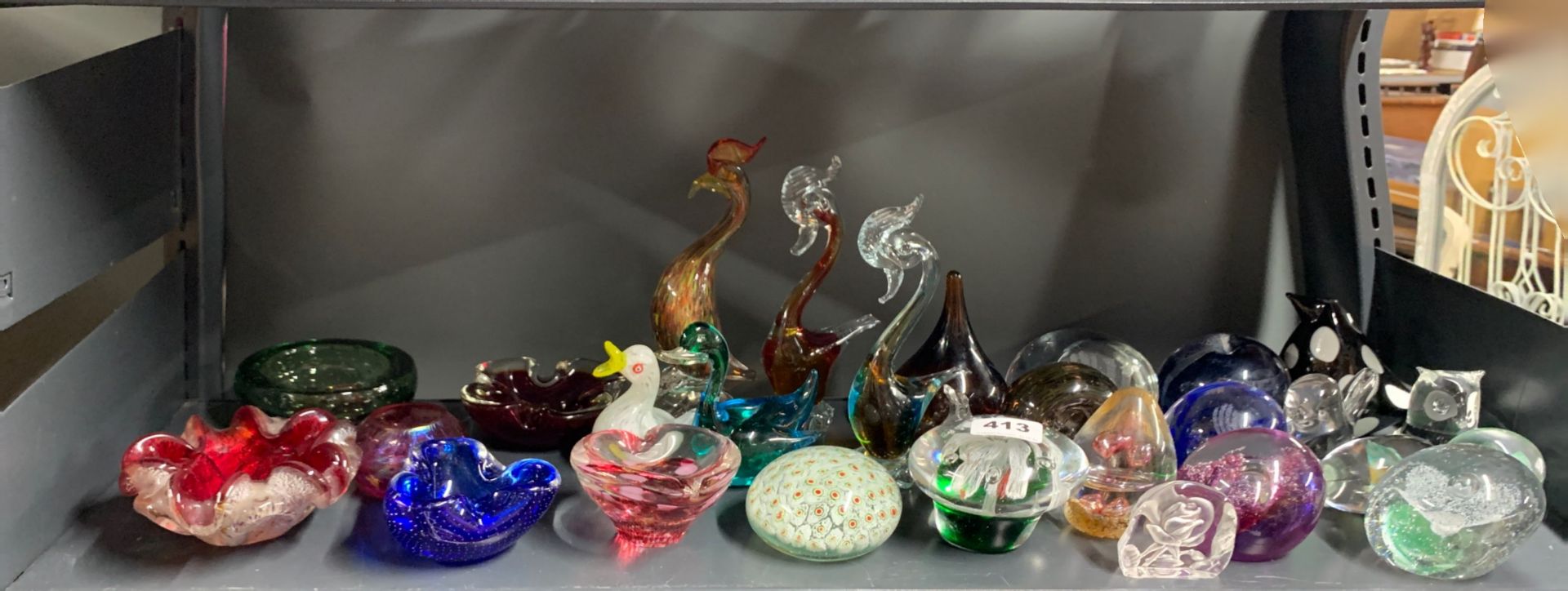 A group of mixed glass paperweights and other items.