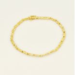 A boxed 9ct yellow and white gold diamond set bracelet, 19.5cm. Two diamonds missing.