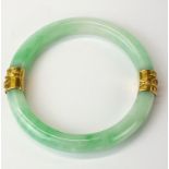A superb Chinese yellow metal mounted (tested 18ct gold) jade bangle, dia. 10.5mm, internal dia. 7.