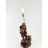 An early 20th century Chinese carved wooden figure mounted as a table lamp, figure H. 42cm.