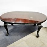 A stained mahogany extendable dining table with ball and claw feet and two leaves, without leaves