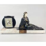 An original Art Deco marble and metal figure mantel clock, W. 62cm.