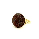 A Victorian 9ct yellow gold (tested) garnet set ring,(R ). One garnet missing.