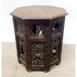An Eastern carved octagonal folding table, W. 45cm H. 51cm together with a folding brass topped