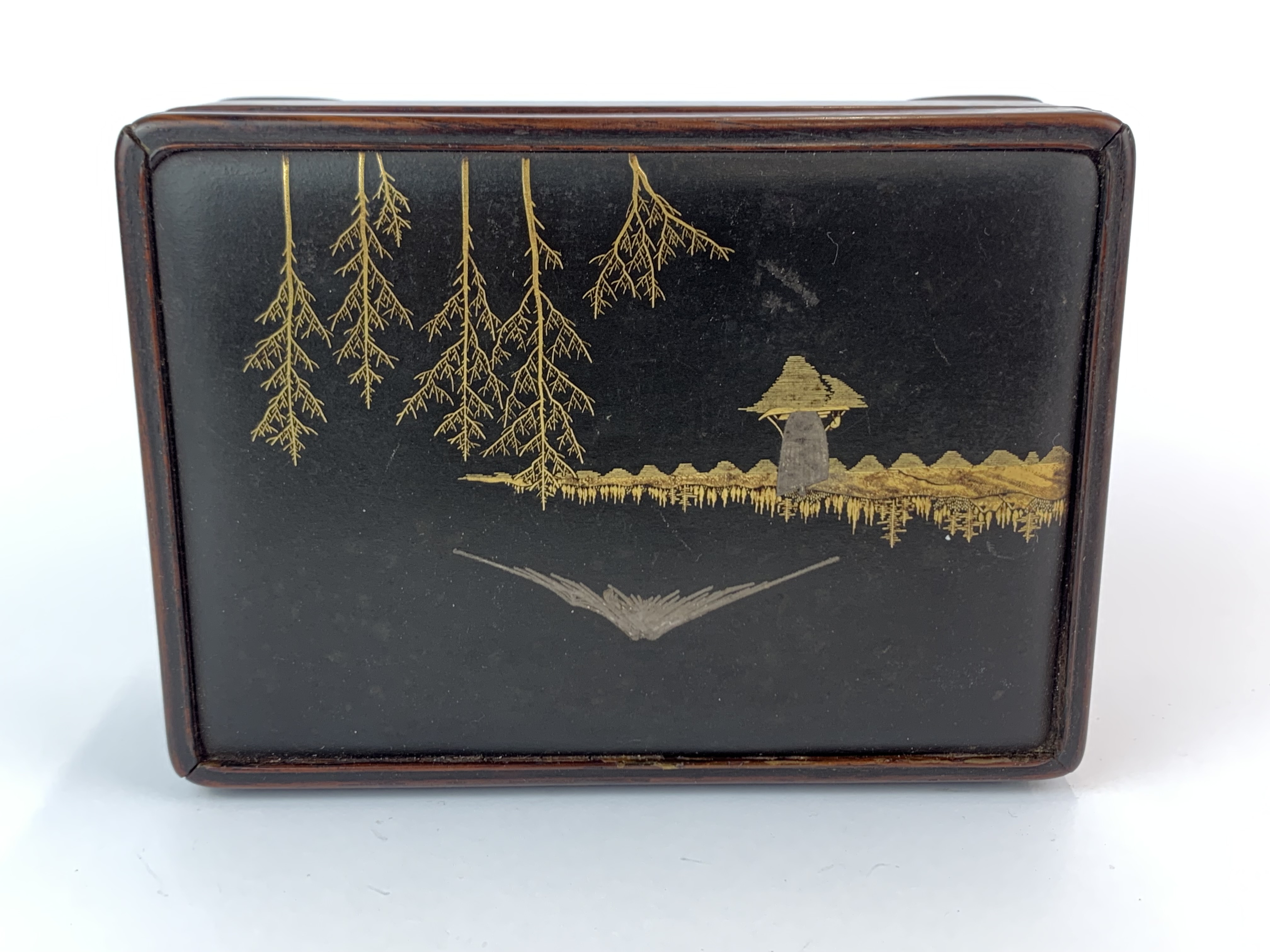 A Japanese hardwood cigarette box inset with a silvered and gilt bronze panel depicting Mount