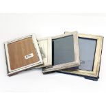 A group of four hallmarked silver photo frames, largest 20 x 25cm.