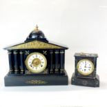 A large 19th C French black slate column mantel clock, W. 44cm, H. 42cm, together with a further