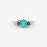 A 9ct white gold (stamped 9K) ring set with apatite, blue topaz and diamonds, (R ).