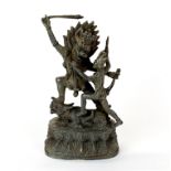 An interesting Tibetan bronze figure of a guardian deity battling a demon, H. 20cm.