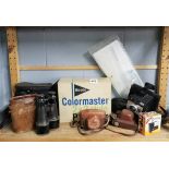 Three pairs of binoculars and a small group of photographic items.