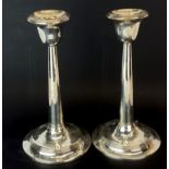 A pair of hallmarked silver candlesticks, H. 21cm.