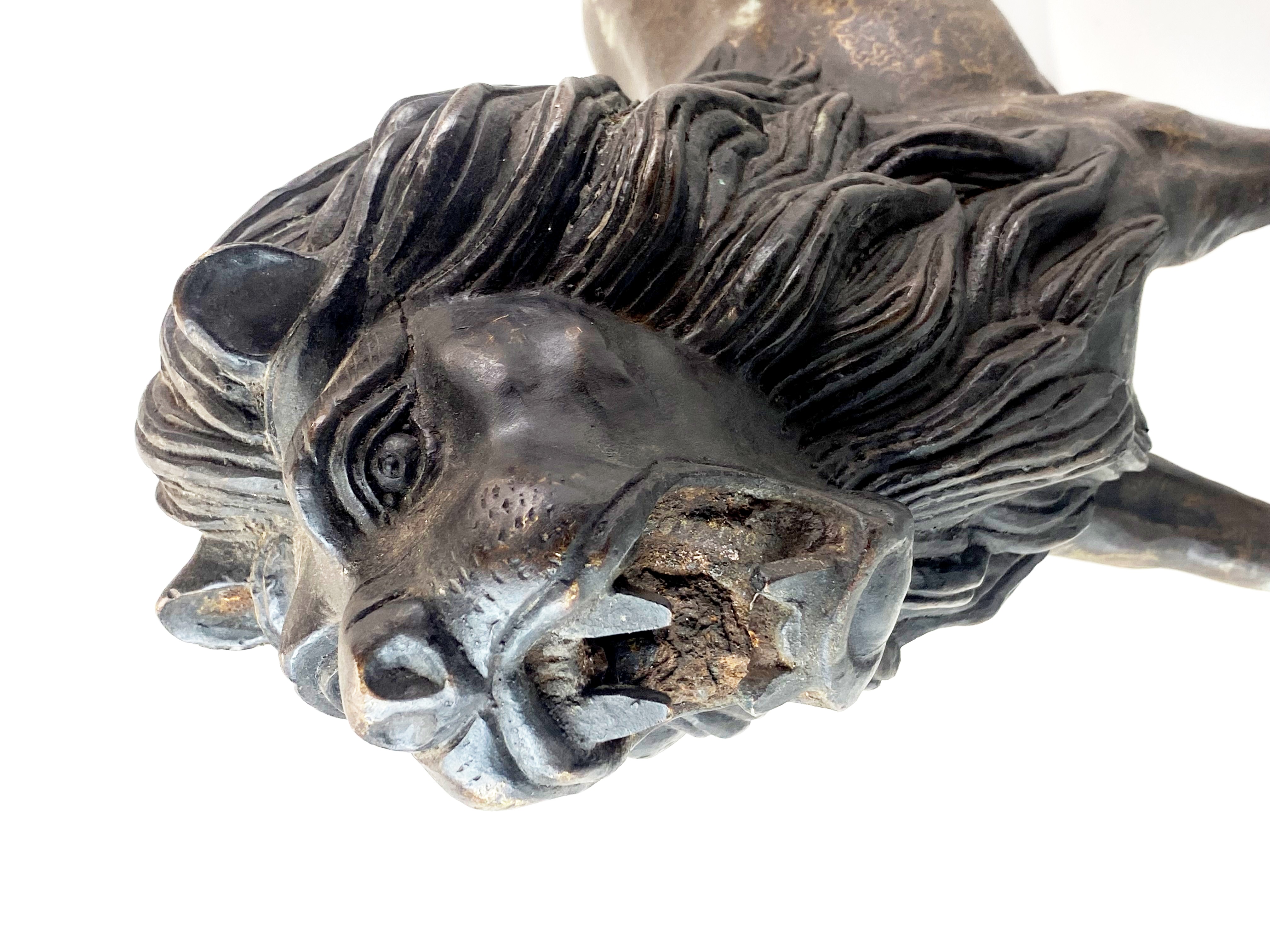 A large bronze figure of a roaring lion with interesting surface decoration, H. 31cm, L. 56cm. - Image 3 of 4