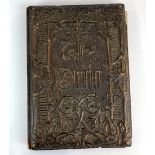 An early carved wooden covered highly illuminated book of 'The Preacher', cover designed by Owen