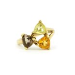 A 9ct yellow gold ring set with a trillion cut smokey quartz, a citrine and a lemon quartz, (L).