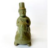 An interesting Chinese celadon glazed pottery figure of a musician riding a mythical animal, H.