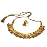 A yellow metal (tested high carat gold, approx. 20ct) and silk cord necklace set with rubies,