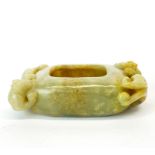 A Chinese celadon and russet jade brush washing bowl surmounted by two young dragons, 9 x 5 x 2.