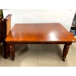 A Victorian mahogany wind out dining table, closed size 122 x 158cm, with two additional leaves,
