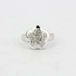 A 14ct white gold flower shaped ring set with brilliant cut diamonds, (L.5).