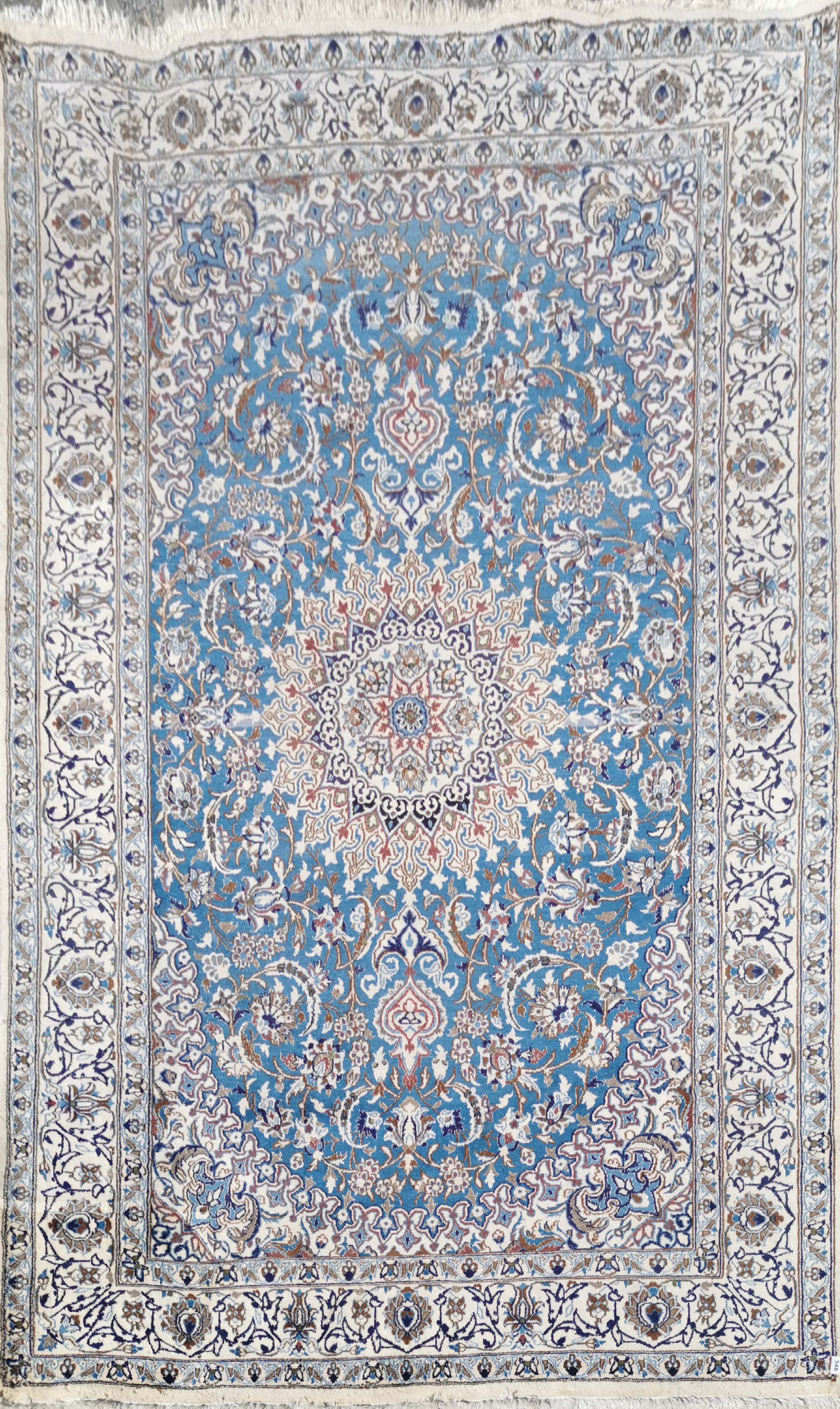 A large Nain, cream and blue ground wool rug, 289 x 198cm.