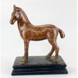 A patinated bronze figure of a horse on a black marble base, H. 36cm.