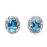 A pair of 925 silver oval cut blue topaz and white stones, L. 1cm.