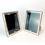 A pair of wooden backed hallmarked silver photo frames, H. 23.5cm.