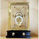 A contemporary gilt brass cased Grasshopper clock, case H. 34cm.
