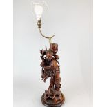 An early 20th century Chinese carved wooden figure mounted as a table lamp, figure H. 42cm.
